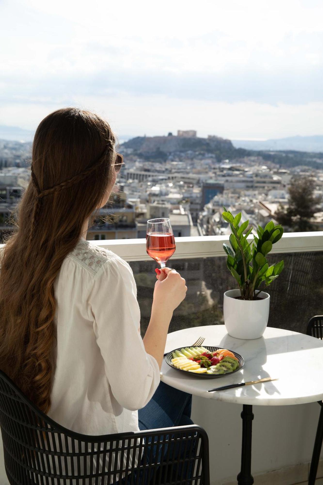 St George Lycabettus Lifestyle Hotel Athens Exterior photo A woman drinking wine